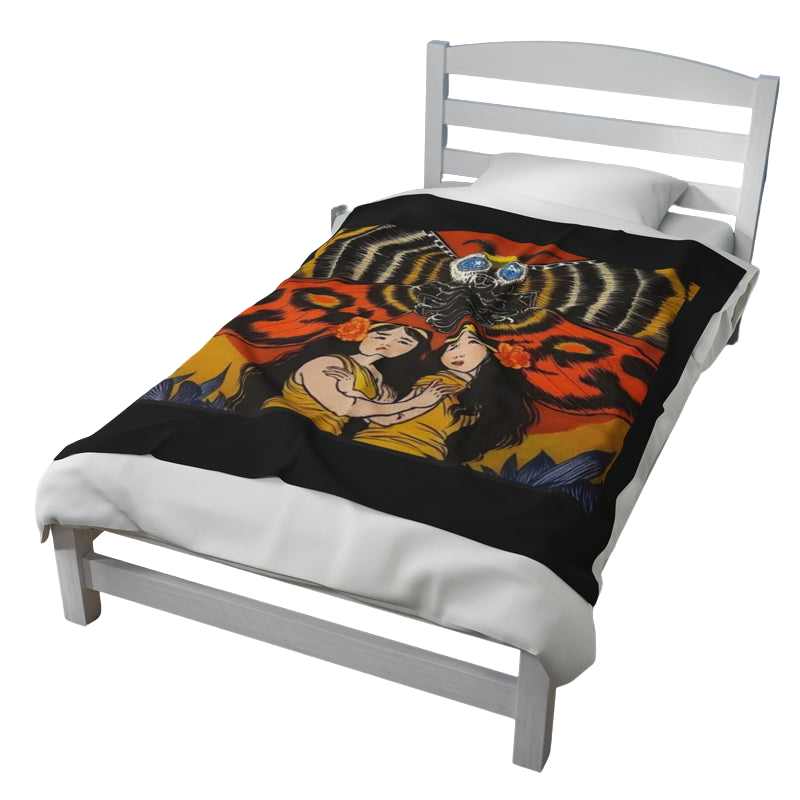 Mothra Fairies blanket draped over bed — cozy and decorative kaiju-themed home accessory